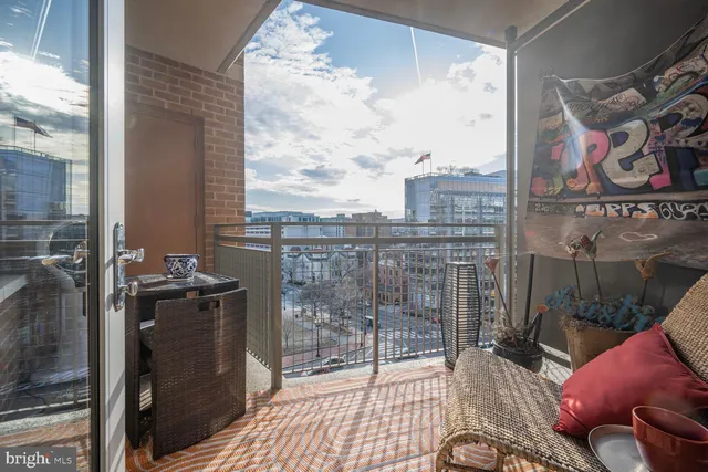 a view of a balcony with furniture and floor to ceiling window