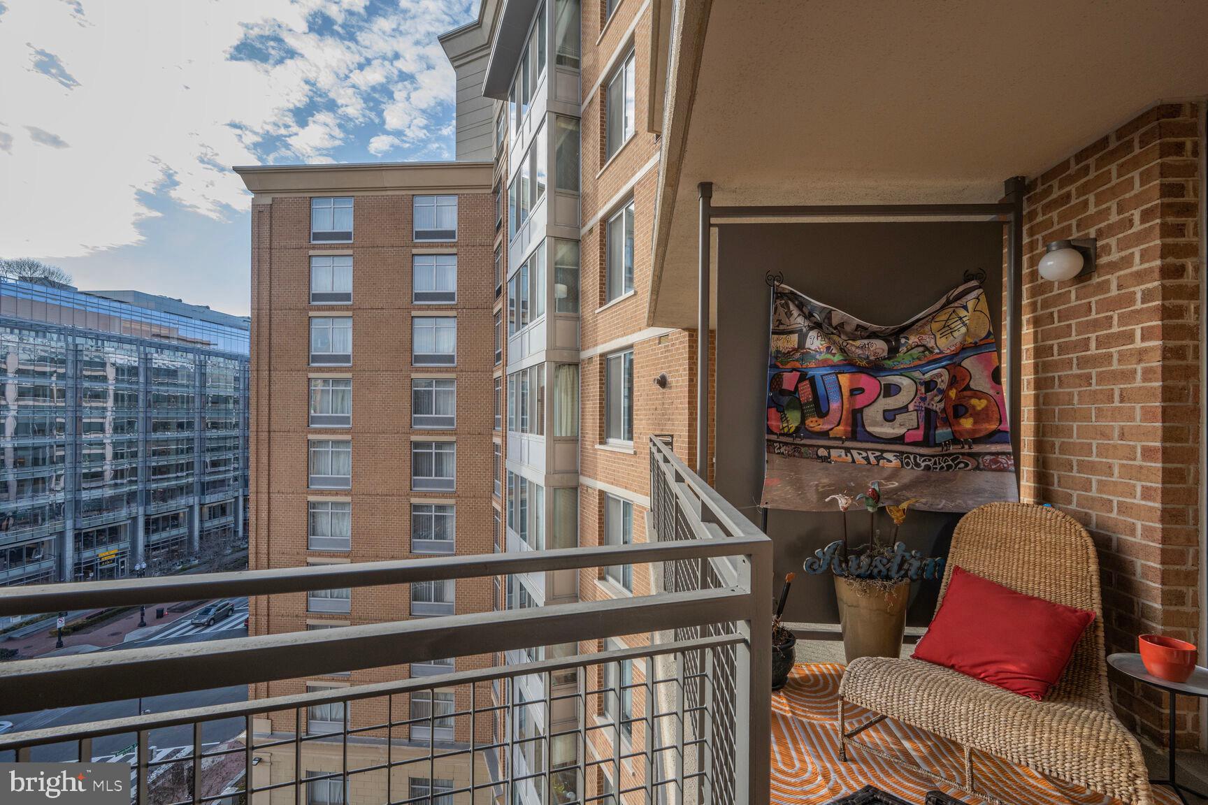 555 Massachusetts Avenue Northwest, Unit 901 Washington, DC 20001 - Photo 8 of 50 a view of a balcony with chairs and potted plants