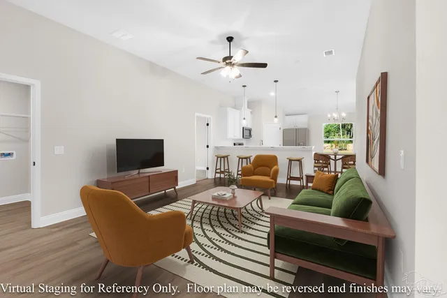 a living room with furniture a rug and a flat screen tv