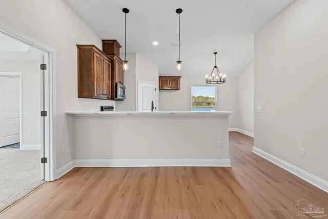 a view of kitchen with granite countertop cabinets and wooden floor