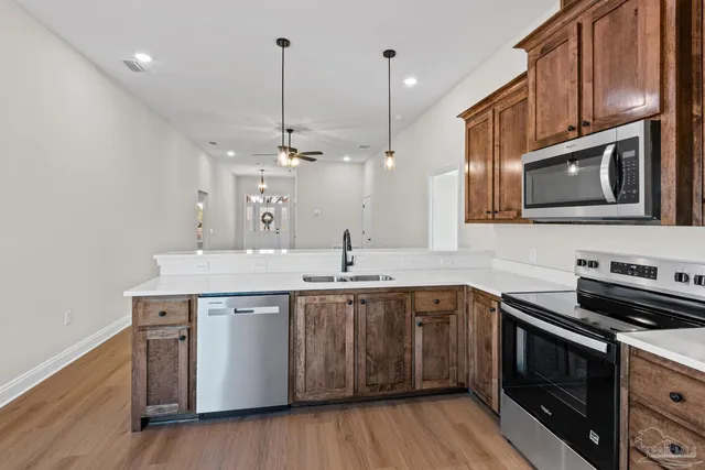 a kitchen with a sink stove and microwave