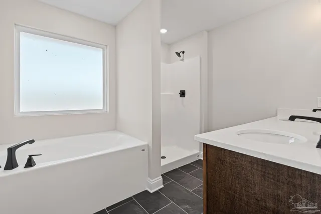 a white bath tub sitting next to a white sink