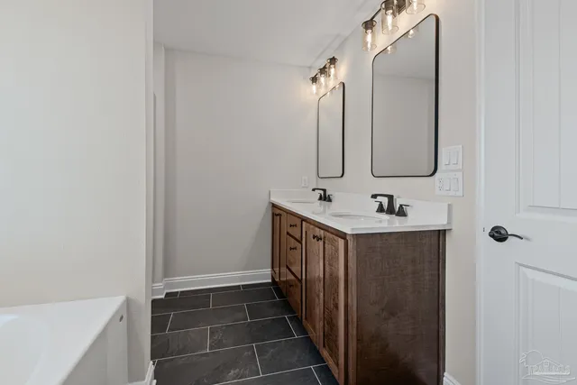 a bathroom with a double vanity sink and mirror