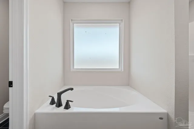a white bath tub sitting next to a window