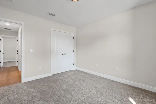 a bathroom with a sink a toilet and a large mirror
