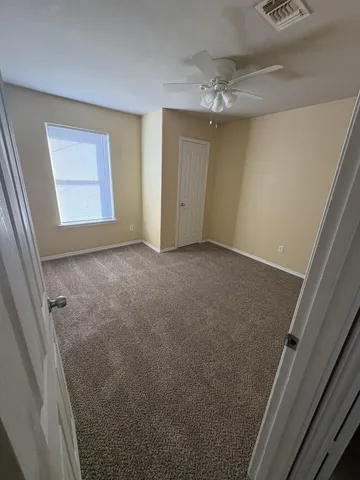 an empty room with wooden floor and a door