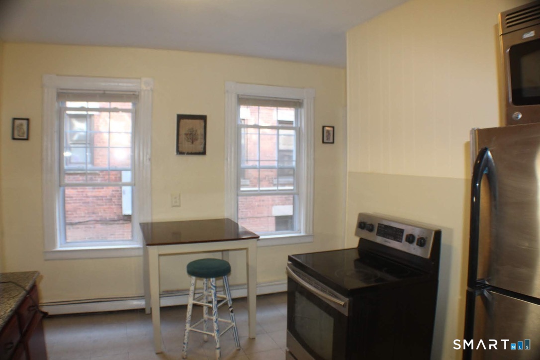 150 Whitney Street Hartford, CT 06105 - Photo 33 of 39 a kitchen with a refrigerator and furniture