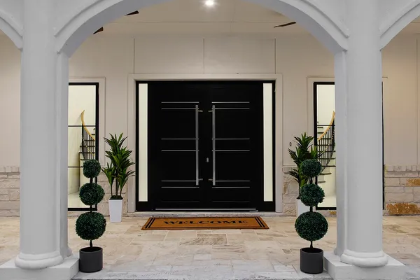 a view of entryway door with potted plant in front of it