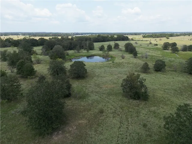 a view of a field with an ocean