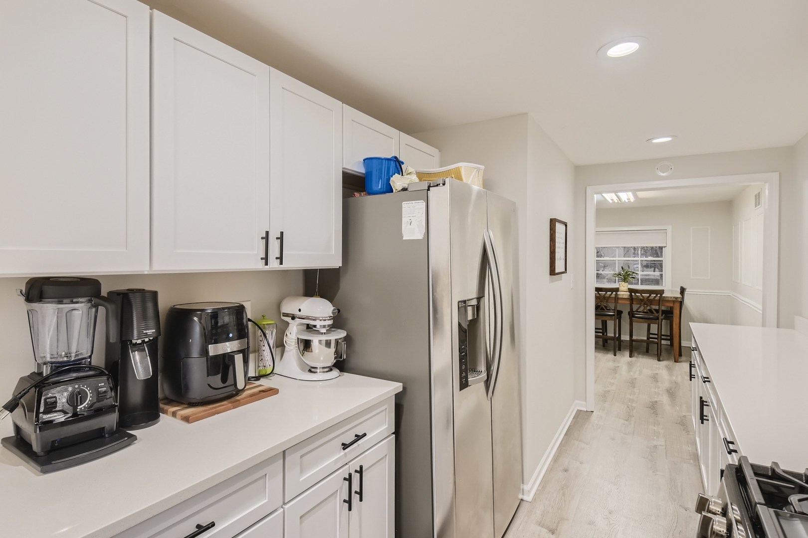 19420 Wolf Road Mokena, IL 60448 - Photo 11 of 32 a kitchen with a refrigerator and white cabinets