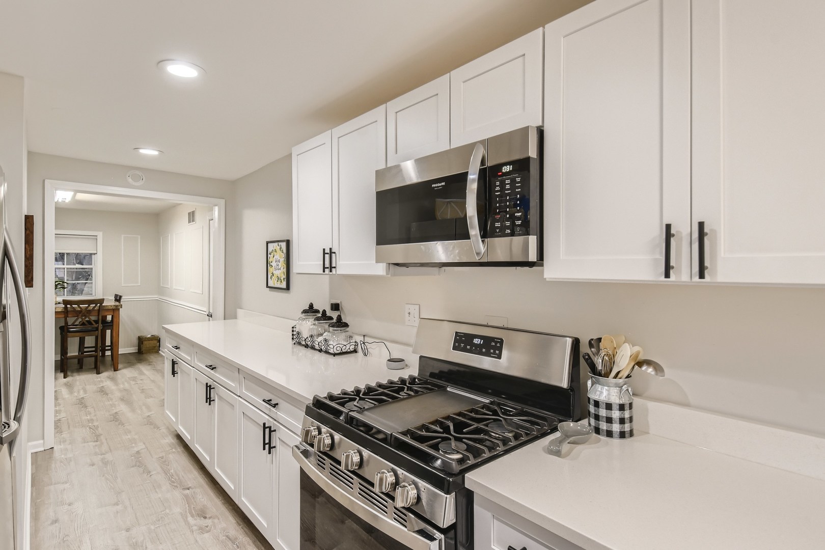 19420 Wolf Road Mokena, IL 60448 - Photo 12 of 32 a kitchen with stainless steel appliances a stove a sink and a microwave