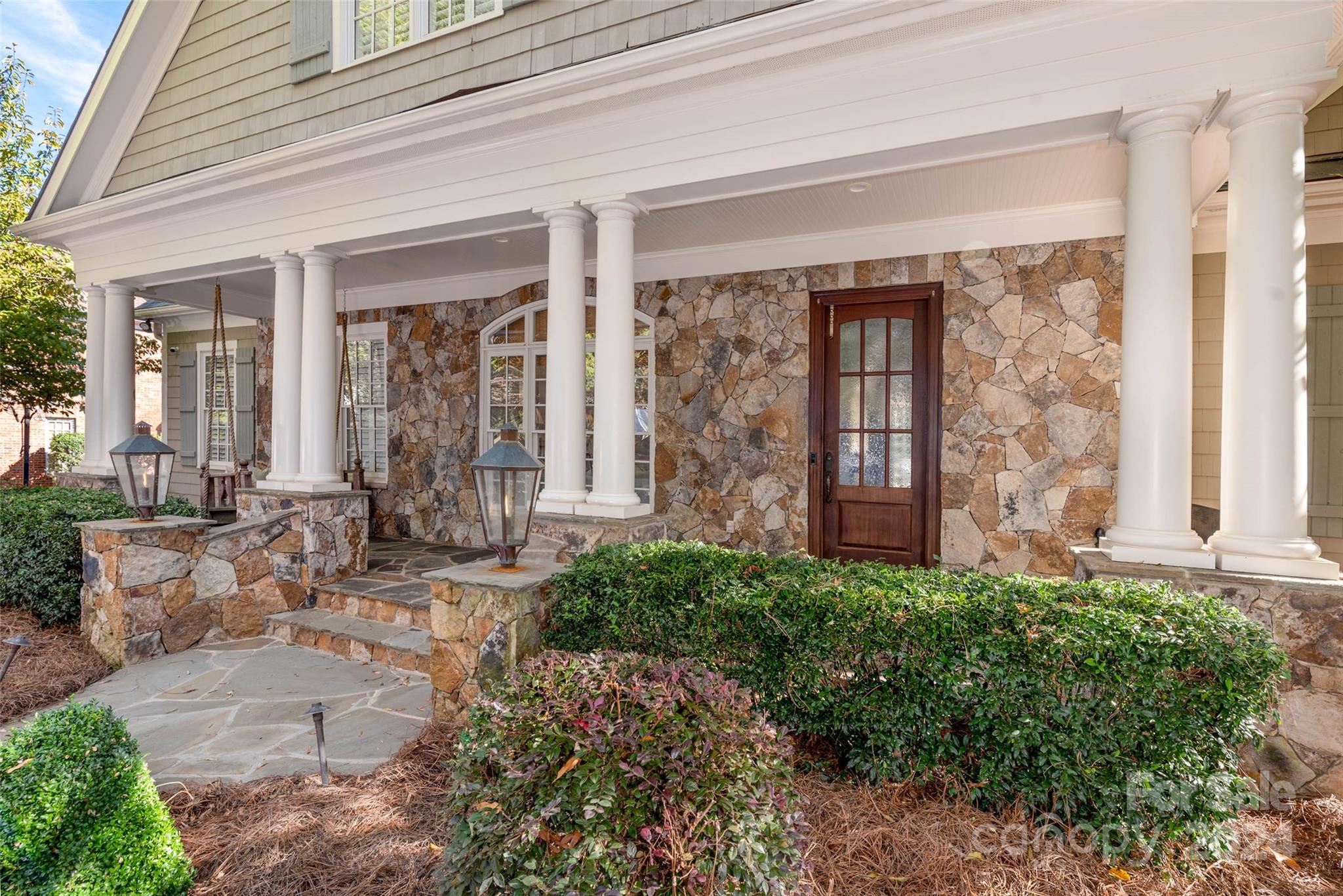 8432 Highgrove Street Charlotte, NC 28277 - Photo 3 of 46 a view of a house with potted plants and a table and chairs