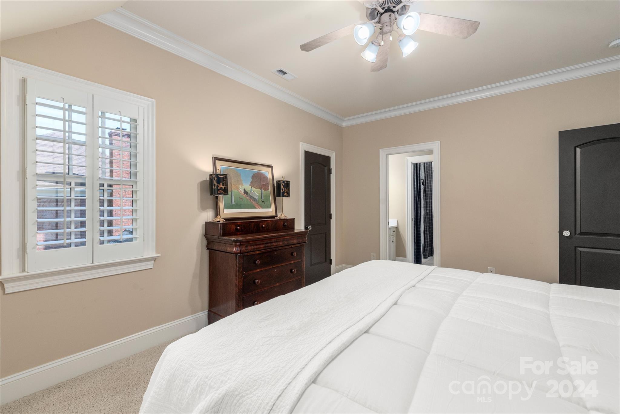 8432 Highgrove Street Charlotte, NC 28277 - Photo 40 of 46 a bedroom with a large bed and a chandelier