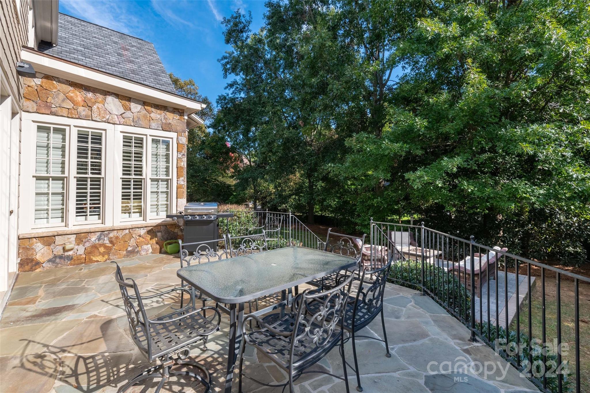 8432 Highgrove Street Charlotte, NC 28277 - Photo 41 of 46 a view of a patio with a table and chairs