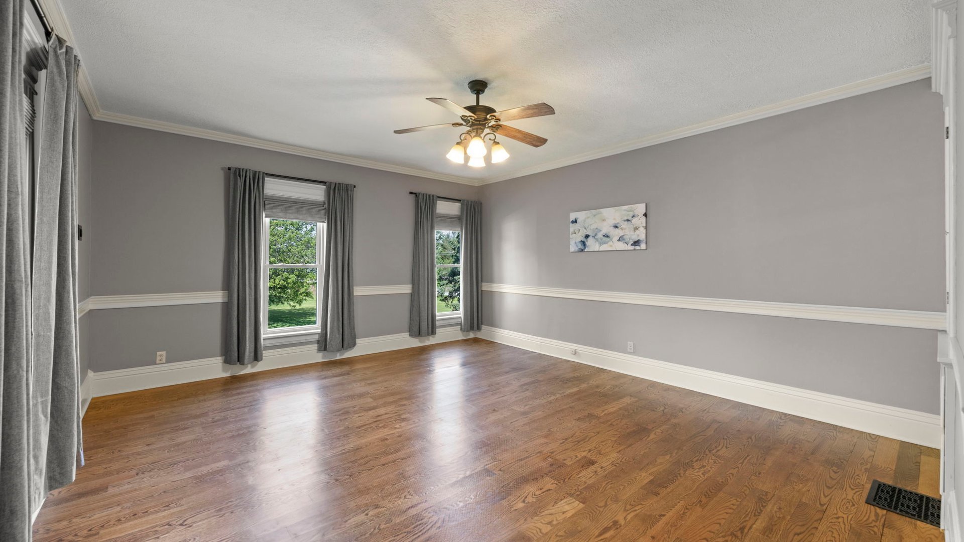 3614 Wolf Road Oswego, IL 60543 - Photo 34 of 56 an empty room with wooden floor chandelier fan and windows