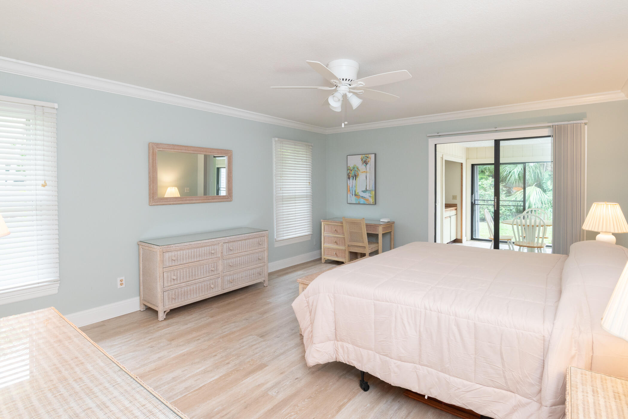 2918 Southeast Fairway West, Unit 13 Stuart, FL 34997 - Photo 19 of 34 a spacious bedroom with a large bed and a chandelier