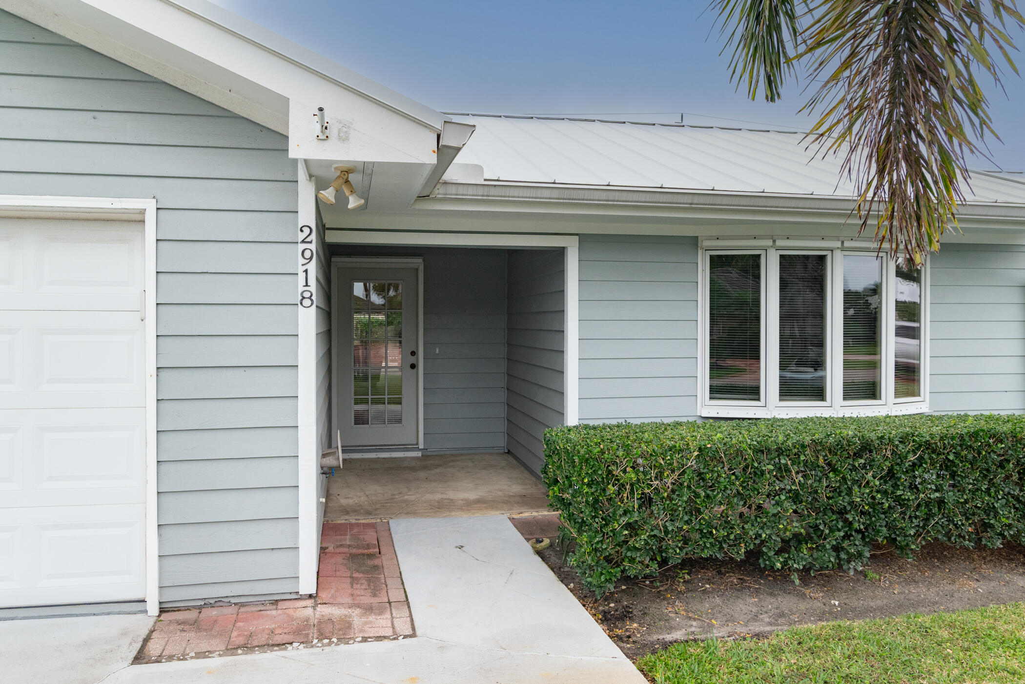 2918 Southeast Fairway West, Unit 13 Stuart, FL 34997 - Photo 2 of 34 a view of a entryway door front of house