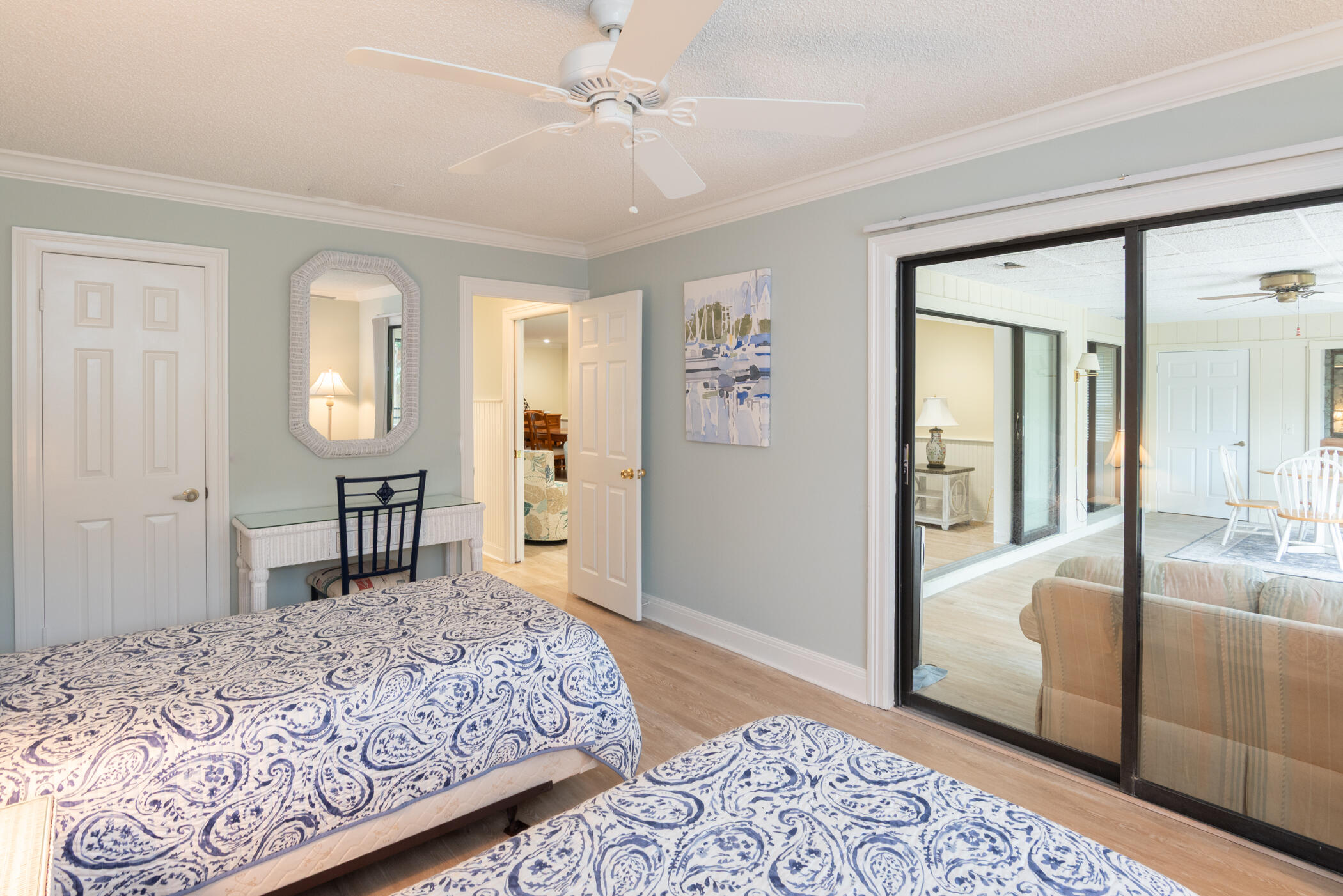 2918 Southeast Fairway West, Unit 13 Stuart, FL 34997 - Photo 26 of 34 a bedroom with a large bed and a chandelier