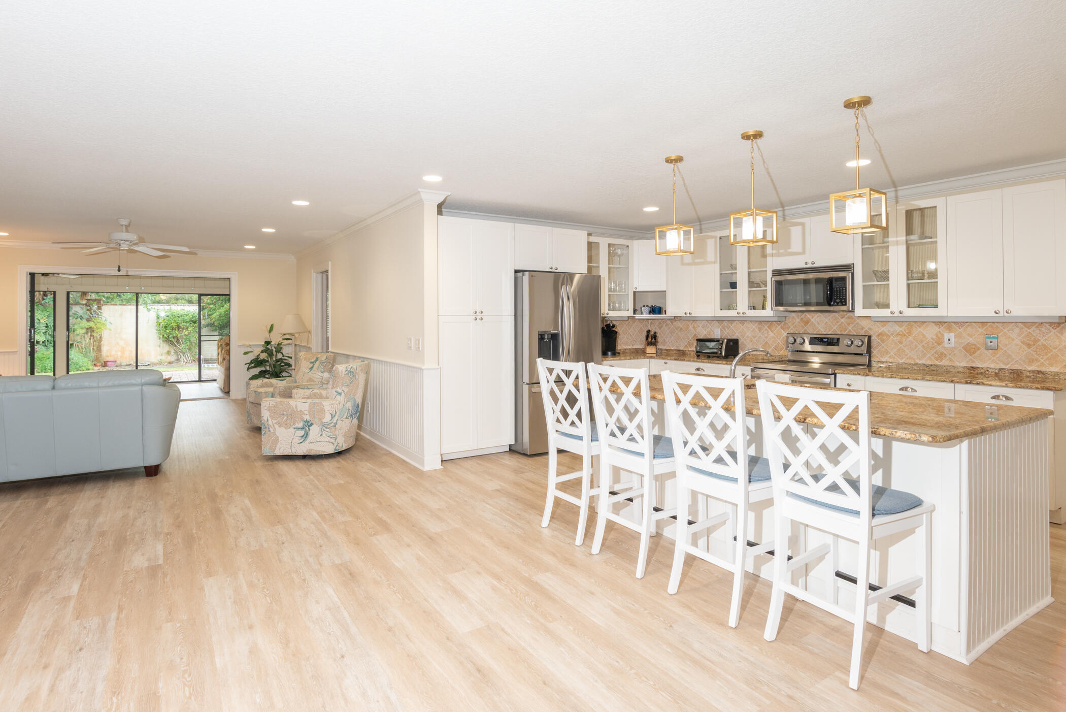 2918 Southeast Fairway West, Unit 13 Stuart, FL 34997 - Photo 3 of 34 a large kitchen with a table and chairs