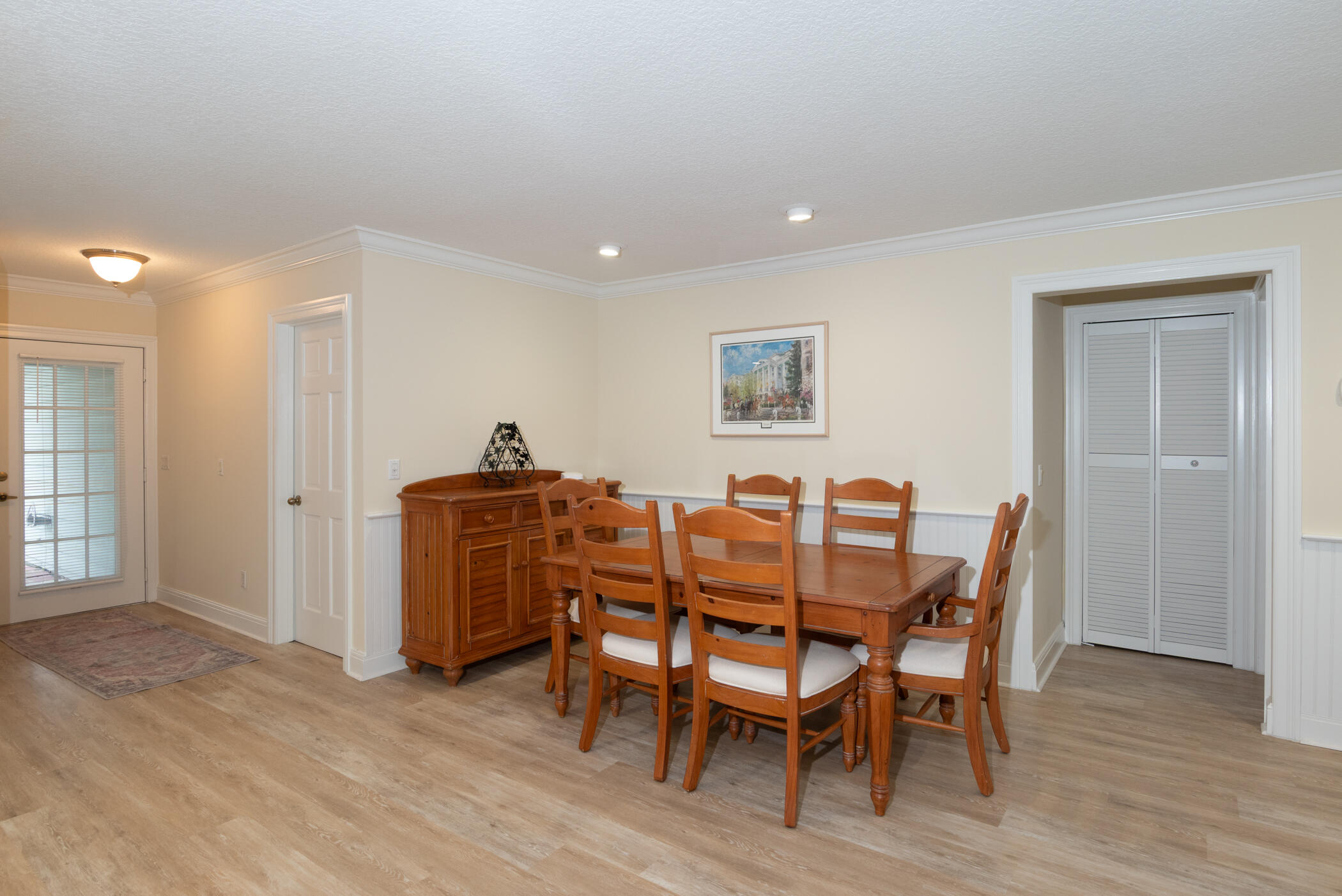 2918 Southeast Fairway West, Unit 13 Stuart, FL 34997 - Photo 8 of 34 a view of a dining room with furniture and wooden floor
