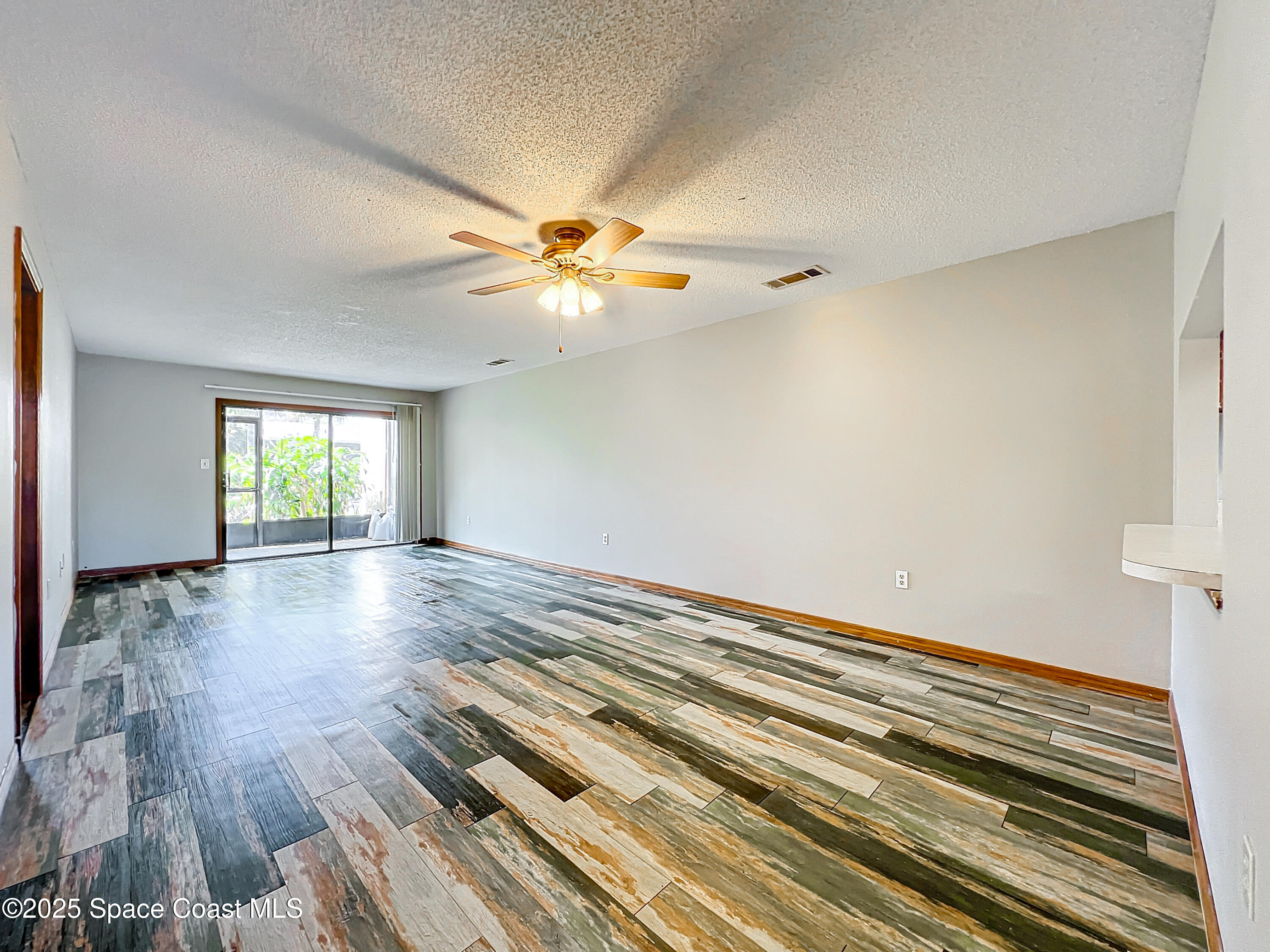 Undisclosed Address Cape Canaveral, FL 32920 - Photo 11 of 45 wooden floor in an empty room with a window