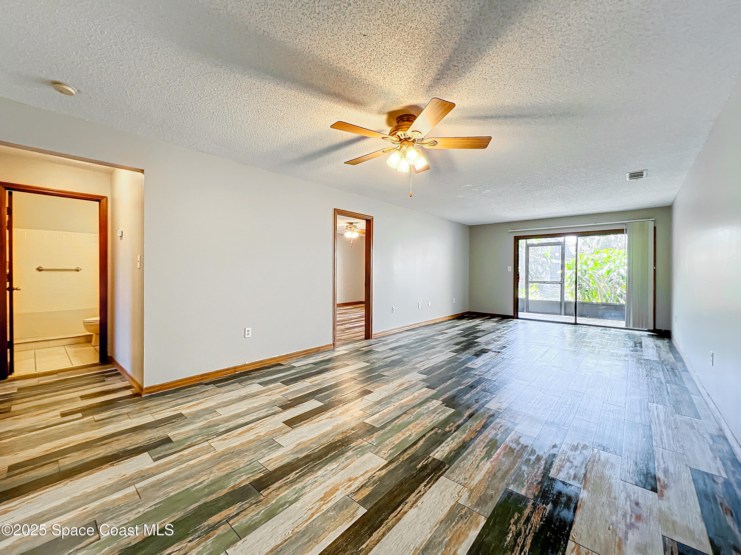 Undisclosed Address Cape Canaveral, FL 32920 - Photo 12 of 45 wooden floor in an empty room with a window