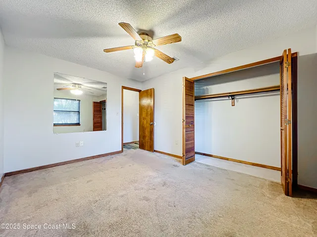 a view of an empty room with a bathroom