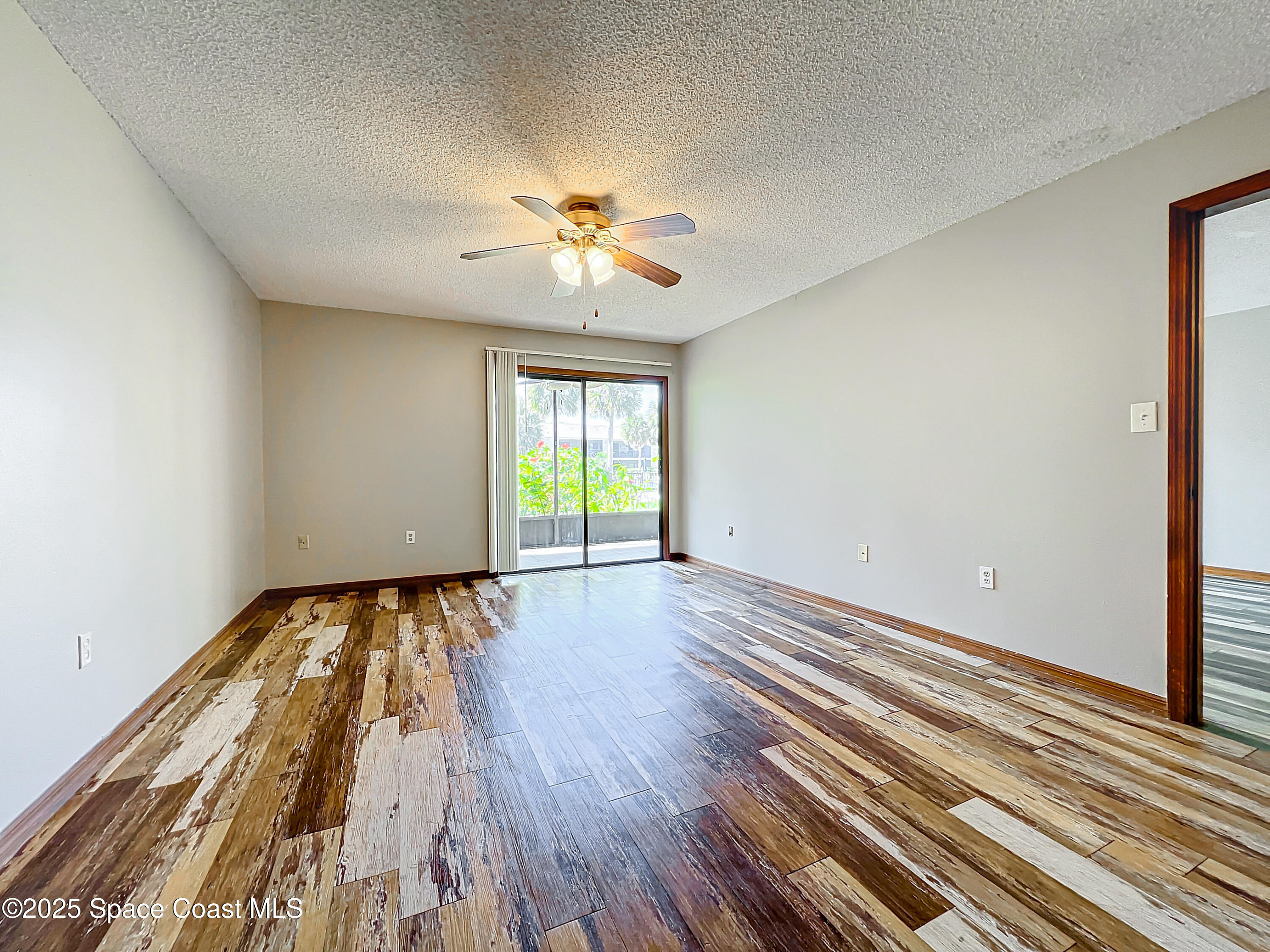 Undisclosed Address Cape Canaveral, FL 32920 - Photo 21 of 45 wooden floor in an empty room with a window