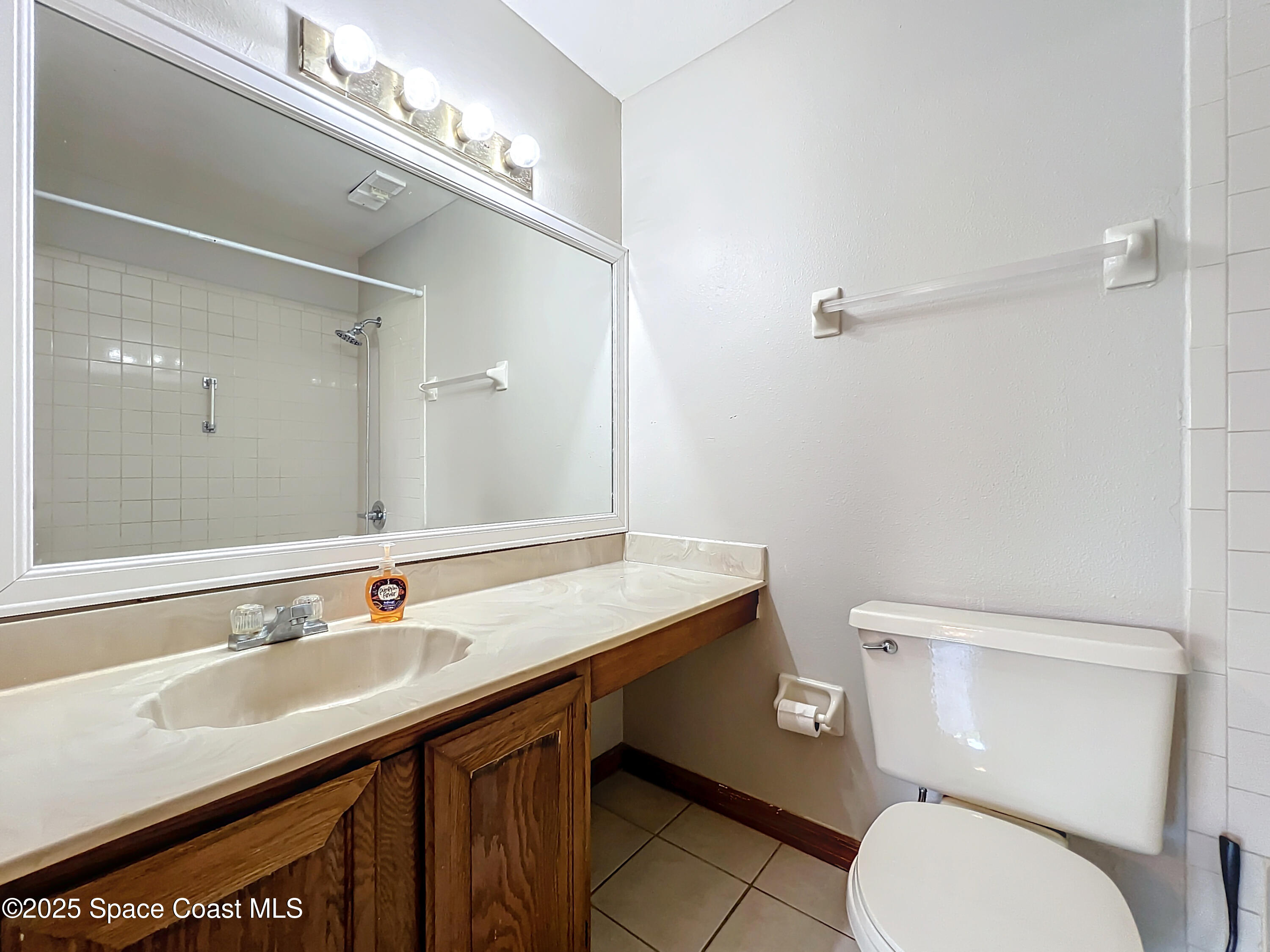 Undisclosed Address Cape Canaveral, FL 32920 - Photo 30 of 45 a bathroom with a granite countertop toilet sink and mirror