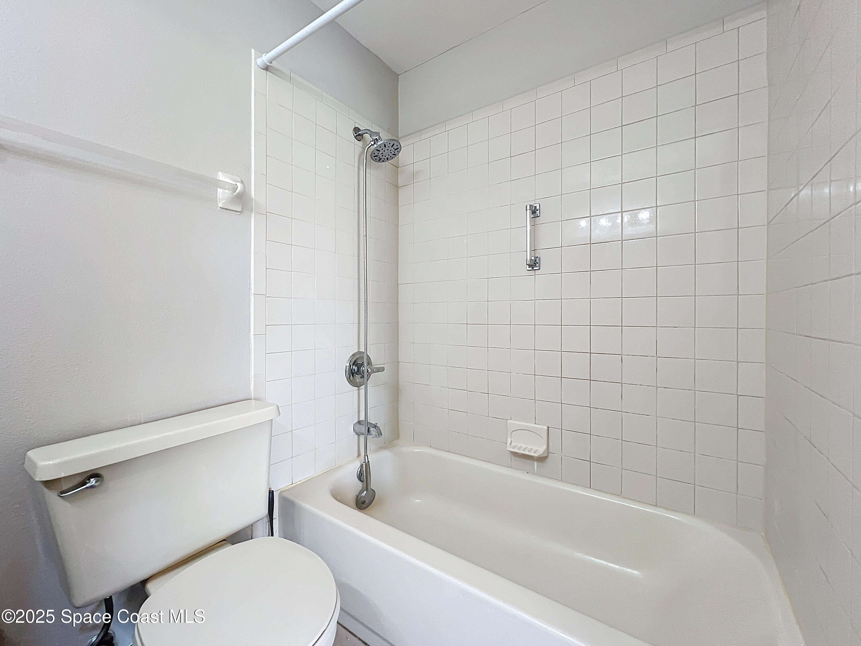 Undisclosed Address Cape Canaveral, FL 32920 - Photo 31 of 45 a white toilet and tub sitting next to a bathroom sink