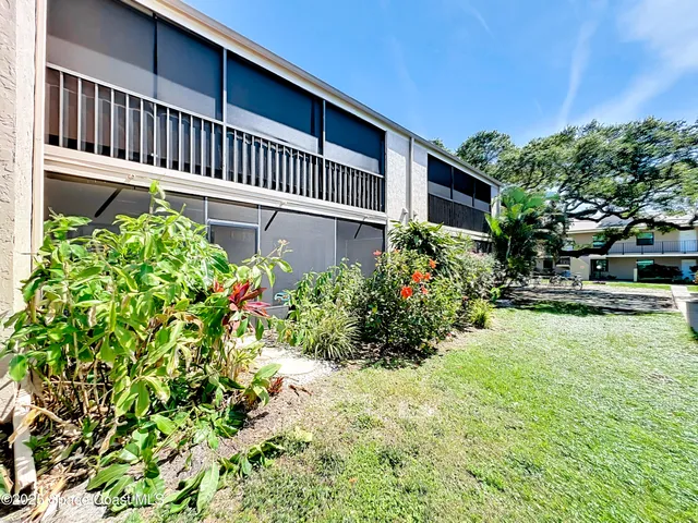 an aerial view of a houses with a yard and lake view