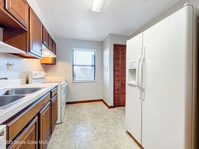 a kitchen with stainless steel appliances granite countertop a sink and a stove