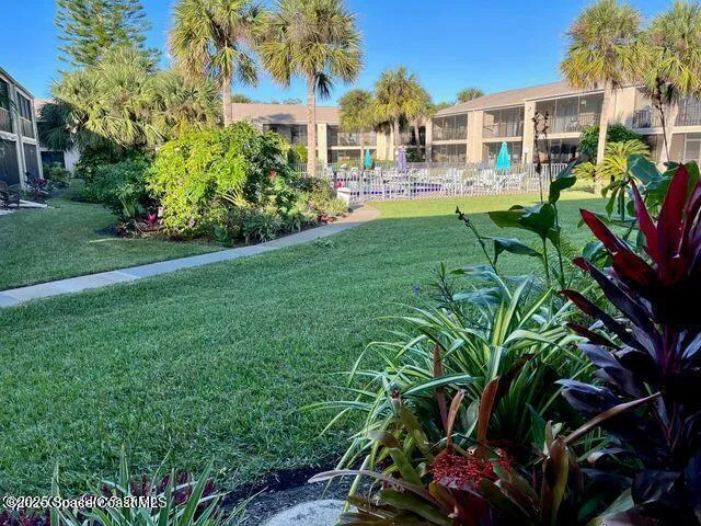 an aerial view of a house with a yard and garden