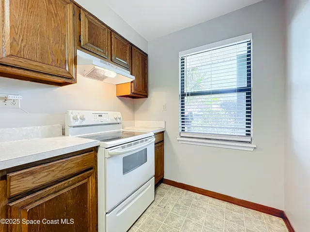 a kitchen with stainless steel appliances granite countertop a stove and a microwave