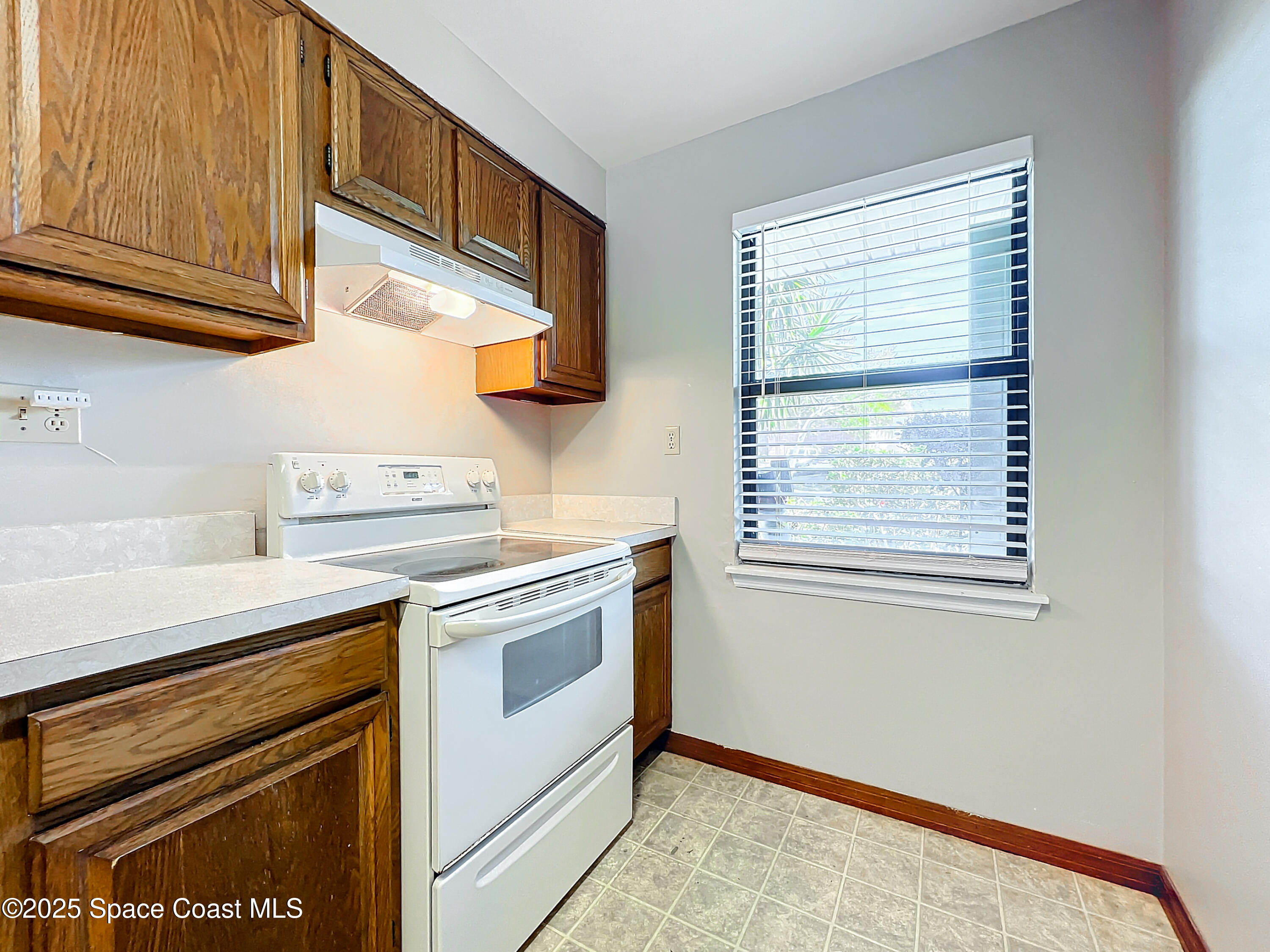 Undisclosed Address Cape Canaveral, FL 32920 - Photo 5 of 45 a kitchen with stainless steel appliances granite countertop a stove and a microwave