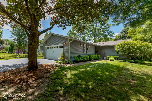 a view of a house with yard and tree s