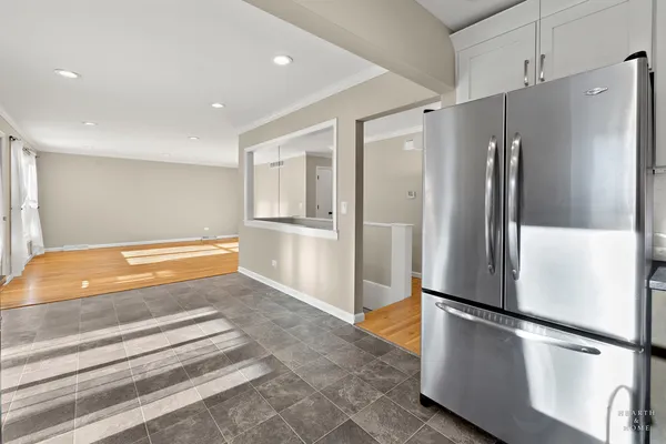 a kitchen with stainless steel appliances refrigerator and microwave