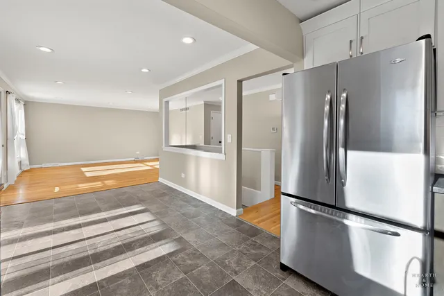 a kitchen with stainless steel appliances refrigerator and microwave
