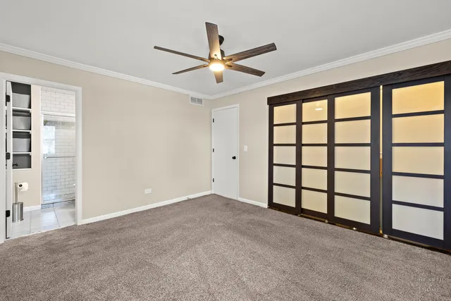a view of a livingroom with a ceiling fan and window
