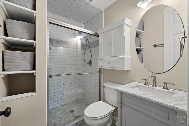 a bathroom with a sink a toilet and shower