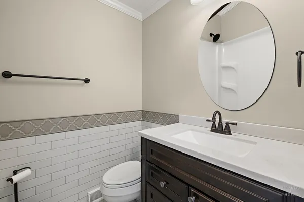 a bathroom with a sink a toilet and a mirror