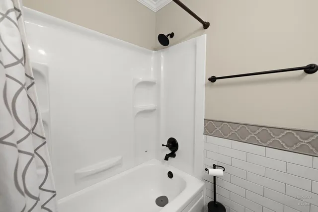 a bathroom with a bathtub and shower