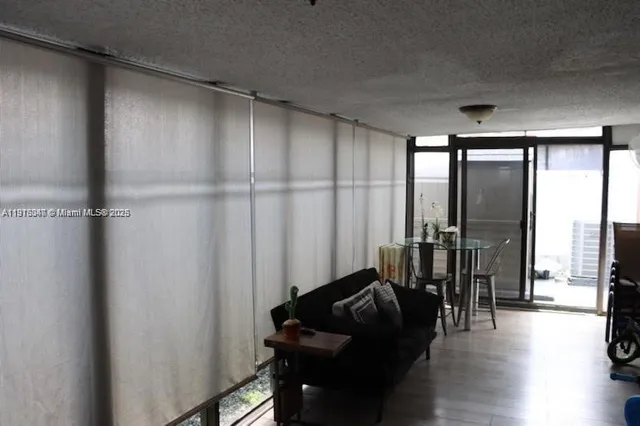 a living room with furniture and a floor to ceiling window