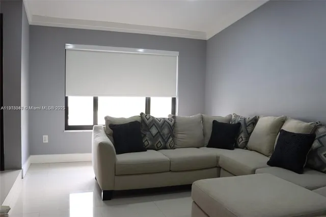 a living room with furniture and a window