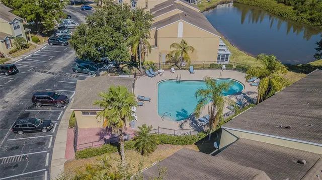 an aerial view of a house with garden space and lake view