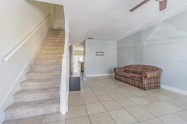 a living room with furniture and stairs