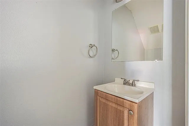 a bathroom with a sink and vanity