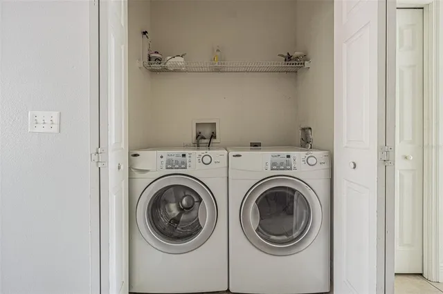 a view of a hallway with washer and dryer