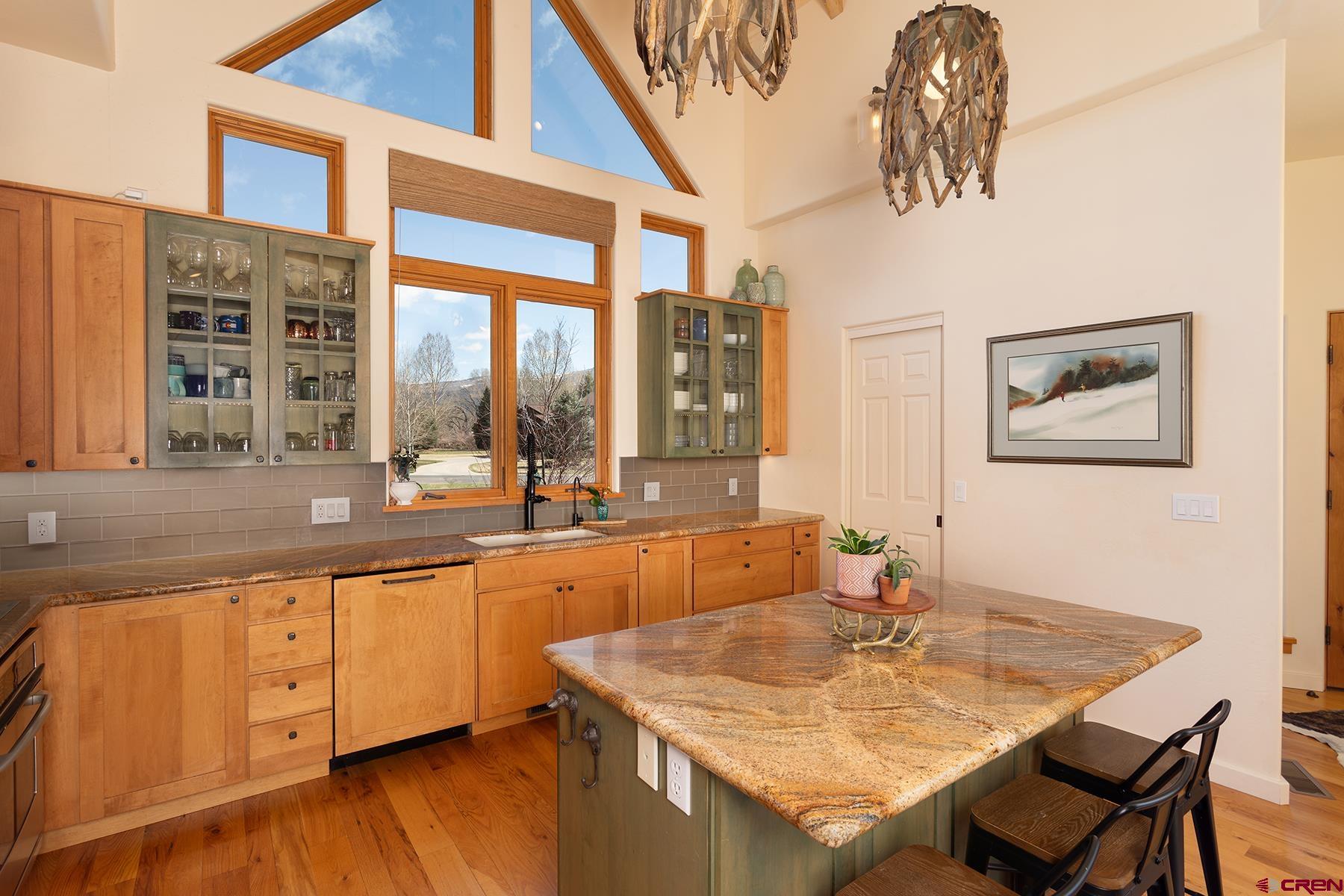 605 Red Rock Road Durango, CO 81301 - Photo 8 of 35 a kitchen with a stove a sink a dining table and chairs