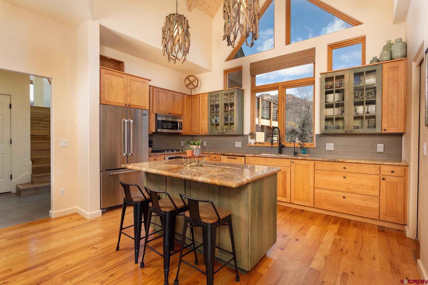 605 Red Rock Road Durango, CO 81301 - Photo 9 of 35 a kitchen with stainless steel appliances granite countertop a table chairs stove and refrigerator